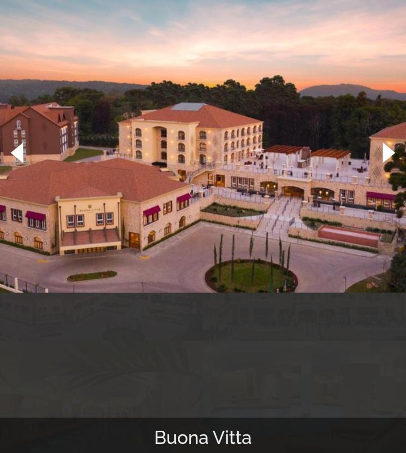 Buona Vitta Gramado Resort & Spa By Gramado Parks Екстериор снимка The image shows a large, modern building complex, likely a hotel or resort. The architecture features a combination of traditional and contemporary design elements. Surrounding the main building are landscaped areas, including trees and green spaces,