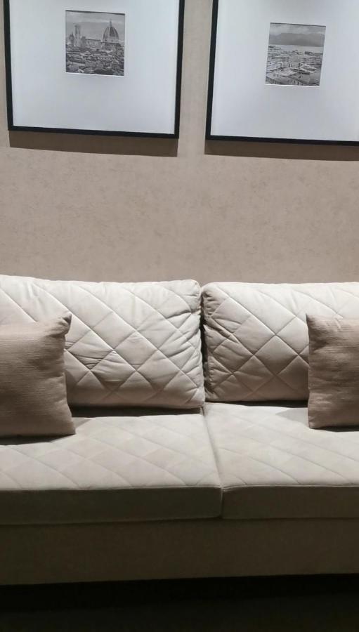 Buona Vitta Gramado Resort & Spa By Gramado Parks Екстериор снимка The photo shows a section of a couch with two large, quilted back cushions that have a diamond pattern. There are also two smaller, square pillows placed in front of the back cushions. The color scheme appears to be neutral, featuring shades of beige