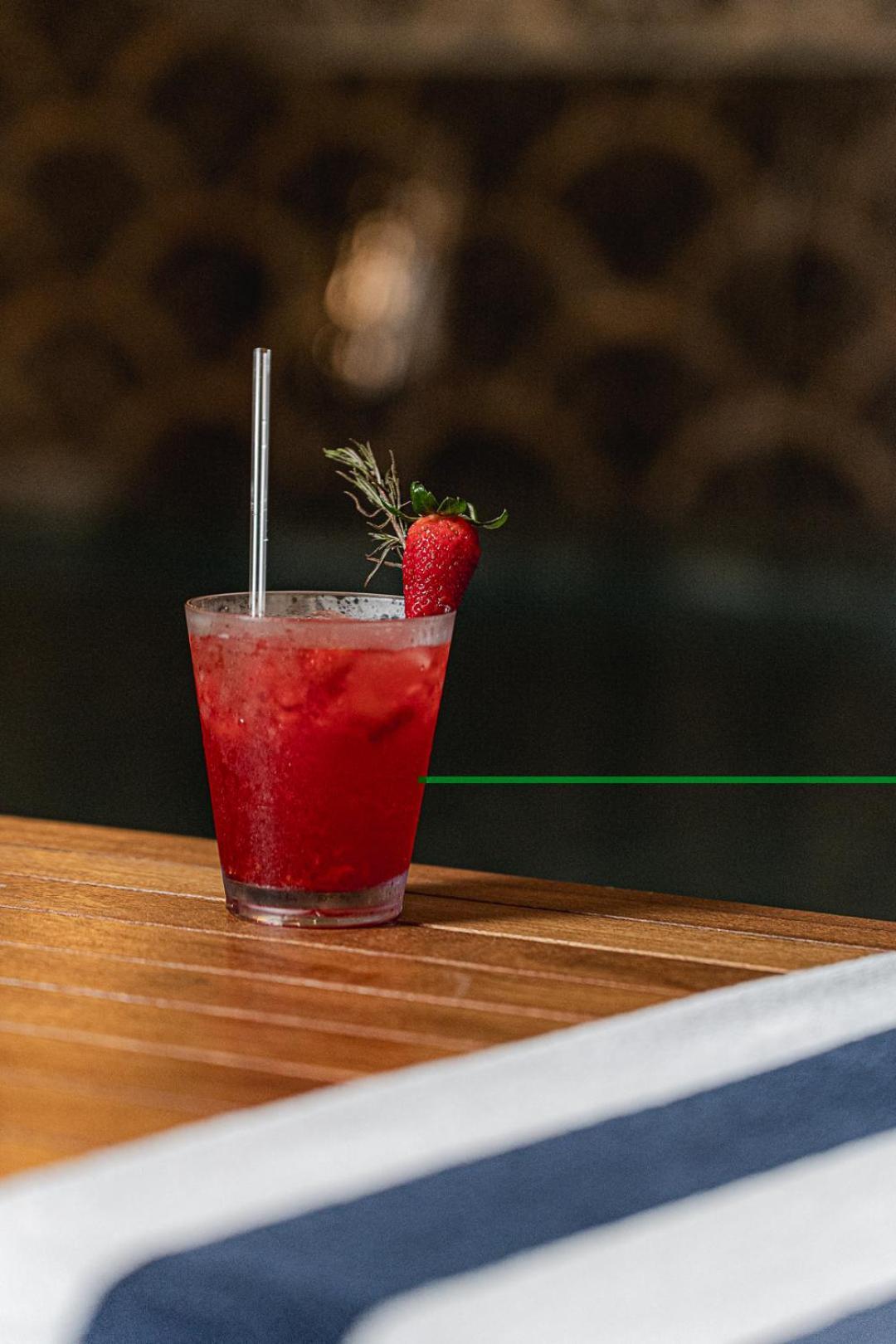 Buona Vitta Gramado Resort & Spa By Gramado Parks Екстериор снимка The photo shows a refreshing cocktail served in a transparent glass. The drink is vibrant red, suggesting it may be made with strawberries or a similar fruit. It features a straw and a garnish of a fresh strawberry on the rim of the glass, along with